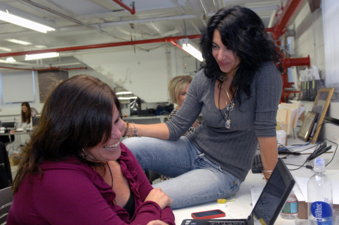 ALEX AND ANI founder Carolyn Rafaelian chats with Allison Carley, director of business to business sales and the company's production facility. Rafaelian was named the 2012 SBA Rhode Island Small Business Person of the Year on Tuesday. / PBN FILE PHOTO/BRIAN MCDONALD