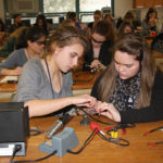 TWO HIGH SCHOOL students take part in a hands-on workshop at the GRRL Tech Expo on Thursday at the University of Rhode Island. / COURTESY TECH COLLECTIVE