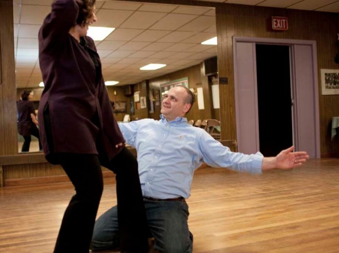 Keith Lavimodiere, vice president and branch manager of Washington Trust’s Reservoir Avenue branch in Cranston, practices his moves with professional dance partner Deborah O’Donnell at The Dancin’ Feelin’ studio in Warwick. Lavimodiere is one of seven “celebrity” dancers at this year’s Dancing with the Stars of Mentoring, a fundraiser and ballroom-dance competition that will be held on April 26th to support the nonprofit Rhode Island Mentoring Partnership. / PBN PHOTO/DAVID LEVESQUE