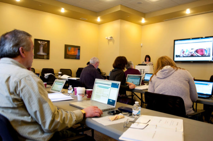 PRESSING IDEAS: Sheila Oliver, standing, instructs a Wordpress class at HarborOne U in Mansfield. HarborOne Credit Union opened the center in June 2010. / PBN PHOTO/CHRIS SHORES PRESSING IDEAS: Sheila Oliver, standing, instructs a Wordpress class at HarborOne U in Mansfield. HarborOne Credit Union opened the center in June 2010. / PBN PHOTO/CHRIS SHORES