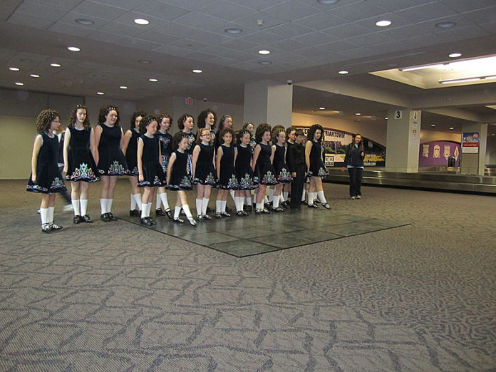 Damhsa Irish Dance Studio students entertain travelers at T.F. Green Airport 
on March 16. The Warwick dance-studio students performed a mix of soft- and hard-shoe dance and group ceili dance during the peak travel time of 4:30 p.m. to 5:00 p.m. The performance was part of the R.I. Airport Corporation’s effort 
to increase community engagement by bringing in musicians and hosting other events at the airport, said Rebecca Pazienza Bromberg, community-affairs 
manager. / COURTESY DAMHSA IRISH DANCE STUDIO