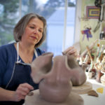 PAINTING ON A NEW CANVAS: Sick of her office job, Betsy Fine set out four years ago to start her own art studio. After attending the Bryant University Women's Summit, she is today the owner-operator of Betsy Cameron Fine Studio. / PBN PHOTO/DAVID LEVESQUE