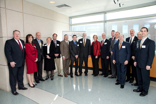 L-R: Ross Nelson, Kristin Fraser, Roger Bergenheim, Mary Wakefield, Chris Burns, Michael Alviano, Lucas Lussier, Michael Jenkinson, Lauren Conway, Anthony Bliss, John Galvin, Alan Lord, David Devault, Robert Kolb, Robert Padula, Brian Schattle / Rupert Whiteley