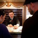 Hotel occupancy in Rhode Island is on the rebound FILLING THE ROOM: Hotel Viking front-desk agent Gavin O'Brien shows Katrina and Sean Northrup of Washingtonville, N.Y., a map of Newport. / PBN PHOTO/STEPHANIE ALVAREZ EWENS
