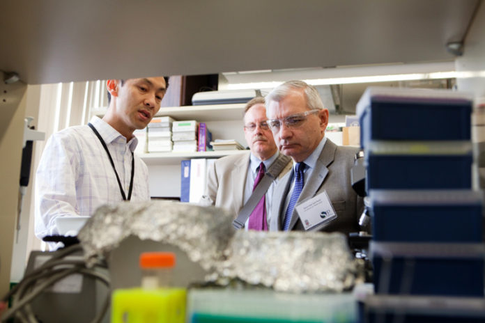 SUPER IDEAS: U.S. Sen. Jack Reed, right, tours the Brown University Laboratories for Molecular Medicine, a research group examining Superfund sites. / PBN PHOTO/RUPERT WHITELEY