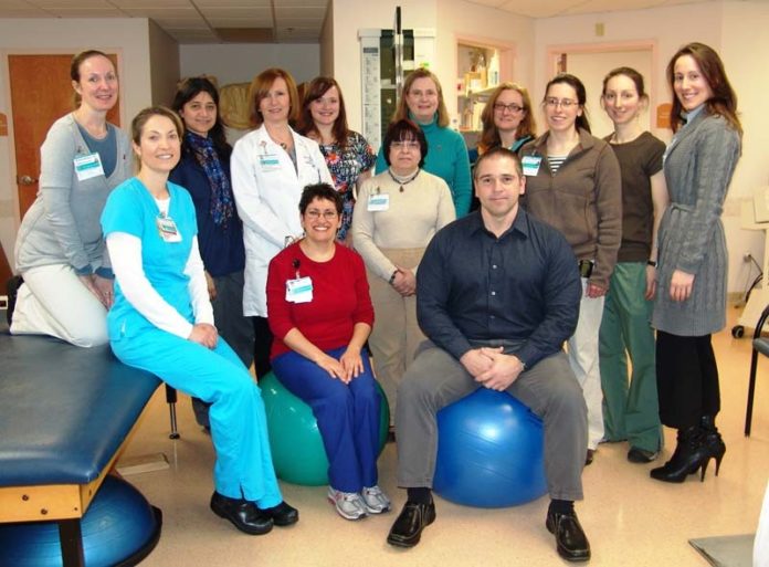 KEVIN SILVIA, front row, right, fundraising organizer, Physical Therapists and Physical Therapist Assistants of Rhode Island; and Ashley DeSimone, back row, right, development and events coordinator, Make-A-Wish Foundation of Massachusetts and Rhode Island; along with staff members from the Miriam Hospital Outpatient and Inpatient Rehabilitation Services Department.