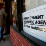 A JOB-SEEKER enters Michigan's Unemployment Insurance Agency Problem Resolution Offices. First-time claims for jobless benefits fell last week to a one-month low, helping allay concern that the labor market may suffer an extended setback. / BLOOMBERG FILE PHOTO/JEFF KOWALSKY