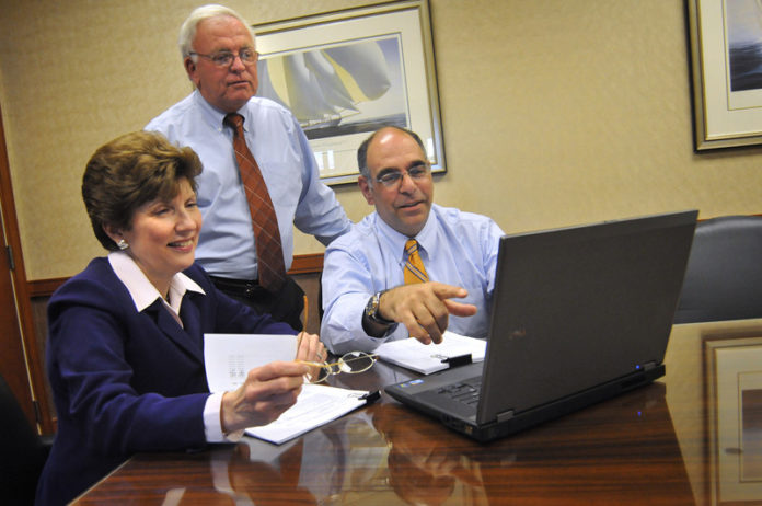STAYING ON BOARD: Sullivan & Co. employees, from left: manager Jacqueline Waldon and principals Timothy J. Sullivan and Michael Hanna. / PBN PHOTO/FRANK MULLIN STAYING ON BOARD: Sullivan & Co. employees, from left: manager Jacqueline Waldon and principals Timothy J. Sullivan and Michael Hanna. / PBN PHOTO/FRANK MULLIN