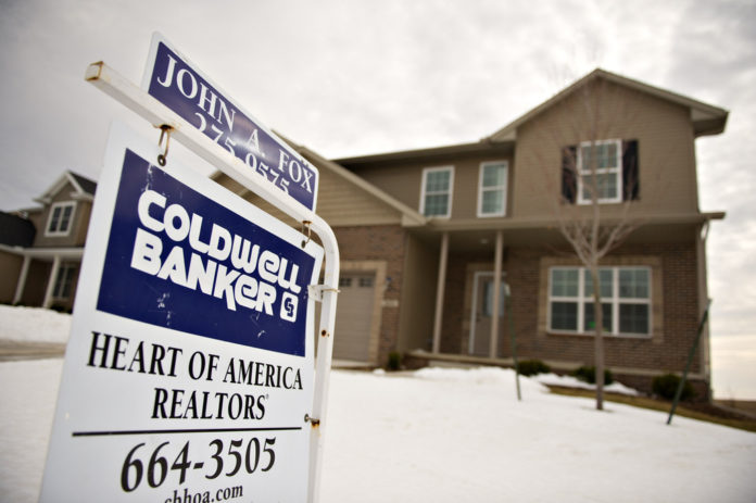 A for sale sign stands outside a new home in Bloomington, Illinois, U.S., on Tuesday, Feb. 15, 2011. Builders began work on more homes than forecast in January, reflecting a surge in multifamily units. / BLOOMBERG FILE PHOTO/DANIEL ACKER