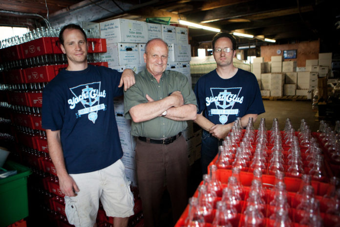 DRINKING IT UP: Nearly a century old, Yacht Club Bottling Works mainly sells to small markets, cafes and restaurants. Pictured above, from left, are John Sgambato, company president, his father, Bill Sgambato, and brother, Mike Sgambato. / PBN PHOTO/RUPERT WHITELEY