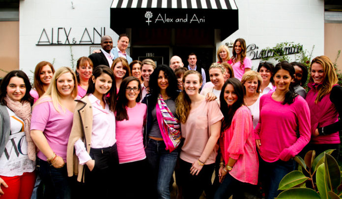 CONNECTION TO CAUSES: Alex and Ani donates 20 percent of sales from its Charity by Design collection to a charity. Staff gather at the company’s Cranston offices to mark fundraising for breast cancer. / Courtesy Alex And Ani