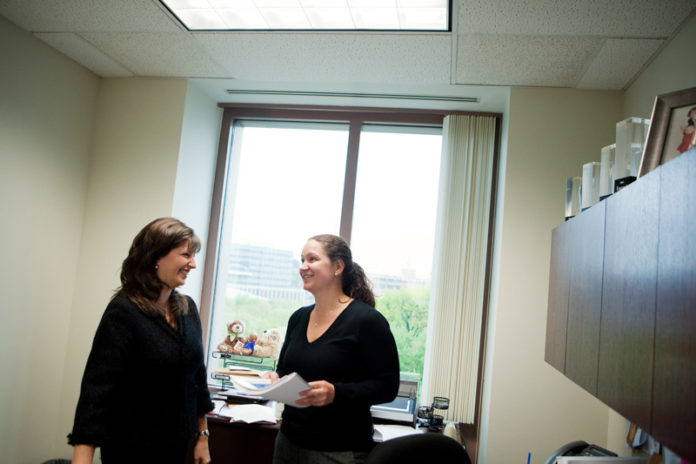 REACHING GOALS: Managing Partner of KPMG’s Providence office, Kristin Fraser, left, confers with Senior Manager Charlene Sweeney. The firm supports staff through a number of programs, allowing them to serve clients to the best of their abilities. / PBN FILE PHOTO/RUPERT WHITELEY