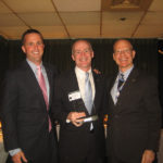 NATIONAL NOTICE: Edward Jones financial adviser John Leary of Barrington, center, receives the Edward Jones Recruiting Award. On left is Kevin Hylander, an adviser. At right is central office host Brian Ashworth.
