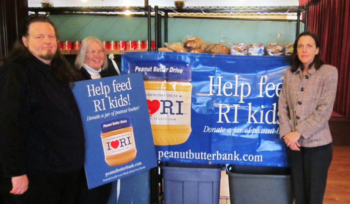 WASHINGTON TRUST CO. recently distributed more than six tons of collected peanut butter to food banks around the state. From left, George Gaffett and Diana Burdett of the Providence In-town Churches Association with Jayne Poland, vice president and branch manager for The Washington Trust Co.