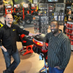 FULL GEAR: Erik Stephens, left, owner of Twisted Throttle, saw his company open its retail location in May after 10 years in business. At right is Marketing Manager Adam Redford. / PBN PHOTO/FRANK MULLIN