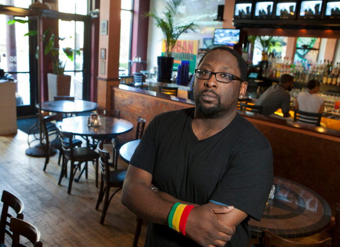 EXTRA SEATING: Shaun Bramble, manager of Cuban Revolution in downtown Providence, said the restaurant has lost a great deal of its lunch crowd since 38 Studios laid off all of its employees in May. / PBN PHOTO/DAVID LEVESQUE EXTRA SEATING: Shaun Bramble, manager of Cuban Revolution in downtown Providence, said the restaurant has lost a great deal of its lunch crowd since 38 Studios laid off all of its employees in May. / PBN PHOTO/DAVID LEVESQUE