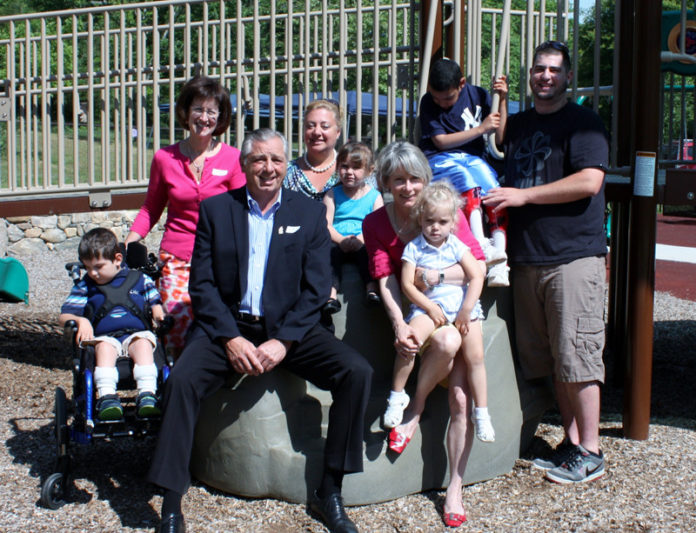 REPRESENTATIVES FROM the Schwartz Center for Children and the Ronald McDonald House Charities of Eastern New England gather at the center’s therapeutic play area with some of the center’s children.