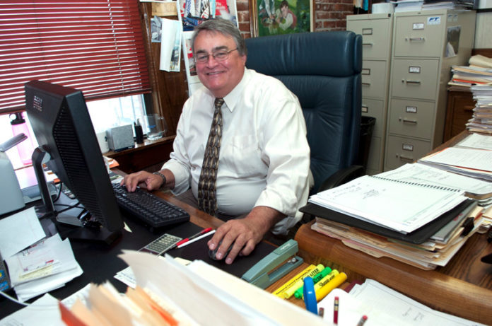 Resource Control Associates Inc. owner Robert C. Atwood, pictured above in his office, thinks of his firm as “a land-development company.”  The 26-year-old Pawtucket business has groups of advisers focused on civil-engineering, environmental assessment and remediation and forensic engineering. Consulting services include insurance-claim investigations. Atwood often provides expert testimony. The firm has worked for more than 50 municipalities and public authorities throughout Rhode Island and Massachusetts, as well as several hundred private clients. / PBN PHOTO/RUPERT WHITELEY