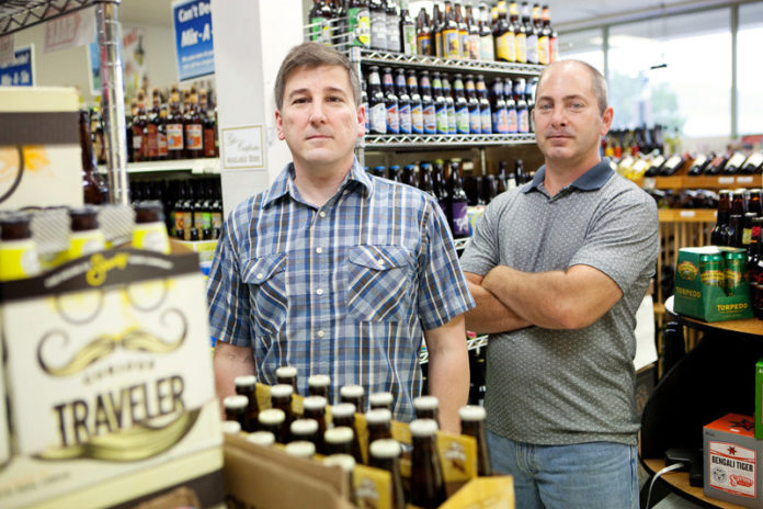 FLOATING IN SUDS: Nikki's Liquors co-owners Michael, left, and David Iannazzi were running four Ronzio Pizza franchises in 2000 when a Providence liquor store went up for sale. Focused on the specialty-brew market, the store carries more than 1,000 varieties of beer. / PBN PHOTO/RUPERT WHITELY