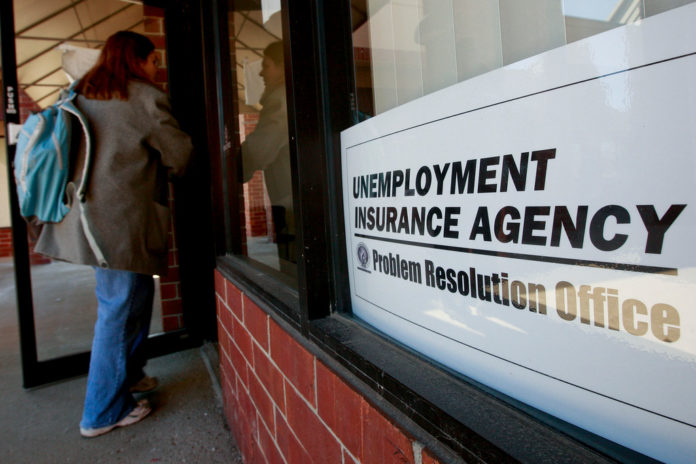 IN RHODE ISLAND, the number of workers filing initial unemployment claims dropped 28 percent during the second quarter. / BLOOMBERG FILE PHOTO/JEFF KOWALSKY