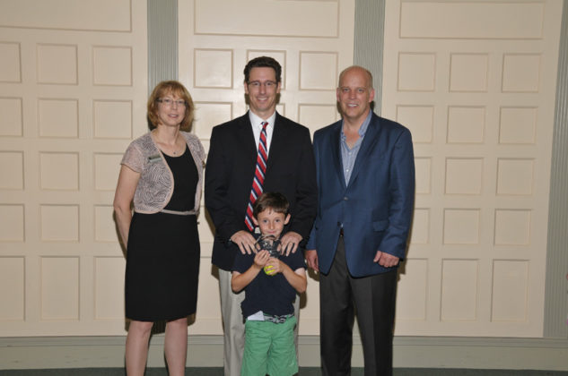 Christopher Ciunci, Founder &amp; CEO of Tribal Vision, accepts his award with the assistance of his son  / Skorski Photography