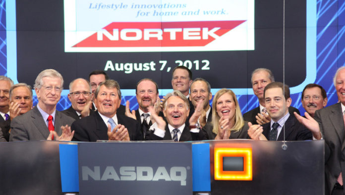 Nortek Inc. President and CEO Michael Clarke and other company executives lead a round of applause after ringing the opening bell for the NASDAQ stock market on Aug. 7 in New York City. Clarke, front row, third from left, said he’s pleased with the performance of the Providence-based residential and 
commercial ventilation maker. “Our brands are well-recognized worldwide 
for their quality and performance,” he said. / COURTESY NASDAQ