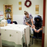 WORKING IT OUT: As part of its wellness program, West View Health Care Center helps employees reduce stress. At right, massage therapist Carole Hesford helps RN Lorraine Eichenfeldt relax. / PBN PHOTO/RUPERT WHITELEY