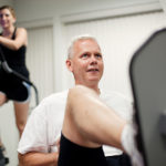 FITNESS PAYS: Sea Corp employees Kim McCarthy, left, and Mark Seyster take advantage of the company&rsquo;s exercise facility, an activity supported by the company&rsquo;s wellness program. / PBN PHOTO/RUPERT WHITELEY