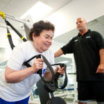 STEEL FROM PLASTIC: Toray Plastics (America) senior account clerk Marie DaBrosca works with 
personal-fitness instructor Josh McCabe. / PBN PHOTO/RUPERT WHITELEY