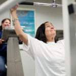 When it comes to wellness, all bases covered BODY AND HEALTH: Partridge Snow & Hahn employees Ellie Malloy, background, and Robin M. Kuznitz take advantage of the law firm’s on-site gym to meet their fitness goals. / PBN PHOTO/RUPERT WHITELEY