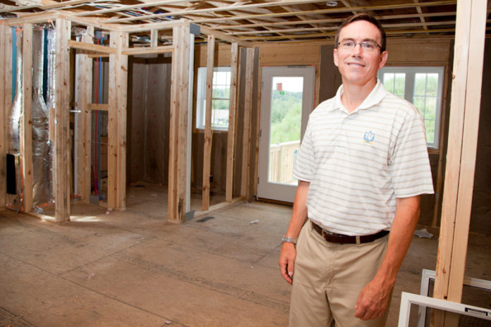 BRANCHING OUT: Thomas McNulty, president of E.A. McNulty Real Estate, at a new 
construction site in Cumberland. “If you were a new-home builder, you had to get into 
new aspects of the industry,” he said. / PBN PHOTO/NATALJA KENT