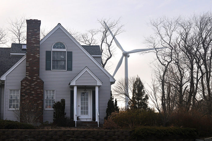 WORTH THE ENERGY? The Portsmouth-owned turbine adjacent to the high school is now broken, with the town recently postponing a decision on whether to spend money to fix it. / PBN FILE PHOTO/FRANK MULLIN