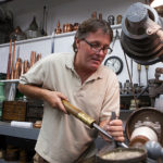 HIRE GROUND: Bill Juaire, co-owner of New England Copper, at work in his Smithfield company&rsquo;s workshop. With revenue up, Bill and his wife, Susanne Juaire, are considering additional hires. / PBN PHOTO/DAVID LEVESQUE