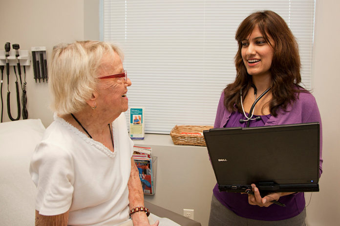 CHANGING TIMES: Syeda M. Sayeed, right, using a laptop to review patient information with Dot Graff at Coastal Medical. / PBN PHOTO/NATALJA KENT