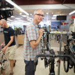 CHAIN OF COMMAND: Caster's Bicycles and Fitness owner Reed Caster, center, is the third-generation owner of the shop. He's pictured above with salesperson John Schmidt, left, and mechanic James Groh. / PBN PHOTO/RUPERT WHITELEY