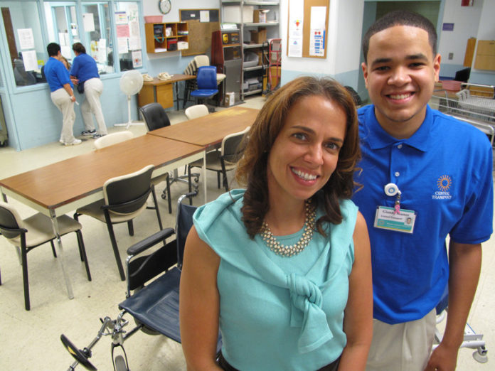 ETERNAL SUMMER: Alexis Devine, head of Lifespan's youth-development program, with recent graduate Gianny Munoz in his new workspace at Rhode Island Hospital. / PBN PHOTO/MARK S. MURPHY