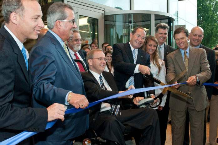 Financed largely by a voter-approved $65 million bond in 2006, the University of Rhode Island opened the new home for the College of Pharmacy last week. Among those in attendance were URI President David M. Dooley (with scissors), and former URI president, Robert L. Carothers, standing behind U.S. Rep. James R. Langevin. / COURTESY URI/NORA LEWIS