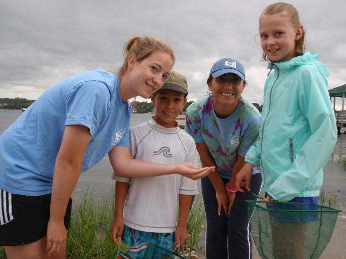 WESTPORT RIVER WATERSHED ALLIANCE interns Katie Daffinee, left, and Ami Araujo, second from right, examine green crabs with Ethan Scheffler and Erin Brisebois.