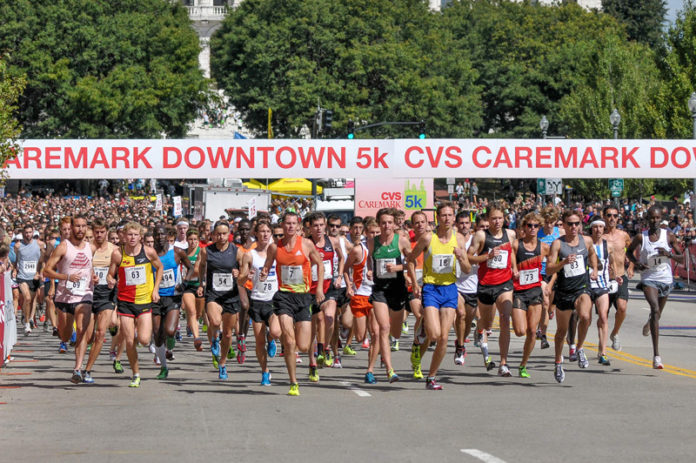 Runners in the 2012 CVS Caremark Downtown 5K hit the streets in Providence Sept. 16. More than 4,400 people participated in the main 5K race while 1,350 children took part in youth races. Along with a host of elite and competitive athletes, recreational runners, wheelchair competitors and walkers joined children to fill out the field. Last year the race raised $75,000 for local charities, bringing the total to that point during CVS Caremark’s 13-year sponsorship to $1.3 million. / COURTESY SCOTTMASONPHOTO.COM