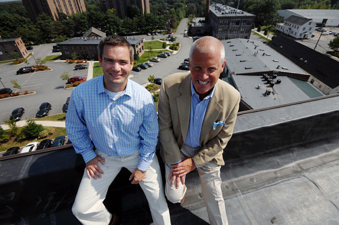 NICE VIEW: Peregrine Property Management principals Jeffrey P. Spratt, left, and Brendan C. Kane sit atop the tallest building at Rumford Center in East Providence, one of the many properties the firm manages. / PBN PHOTO/BRIAN MCDONALD