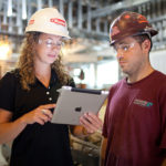 Seamless evolution with the right mindset, tools OLD SCHOOL, NEW TOOLS: Gilbane Assistant Project Engineer Mallory Prentiss checks the progress of a job with electrician Jeffrey Silva. / PBN PHOTO/RUPERT WHITELEY