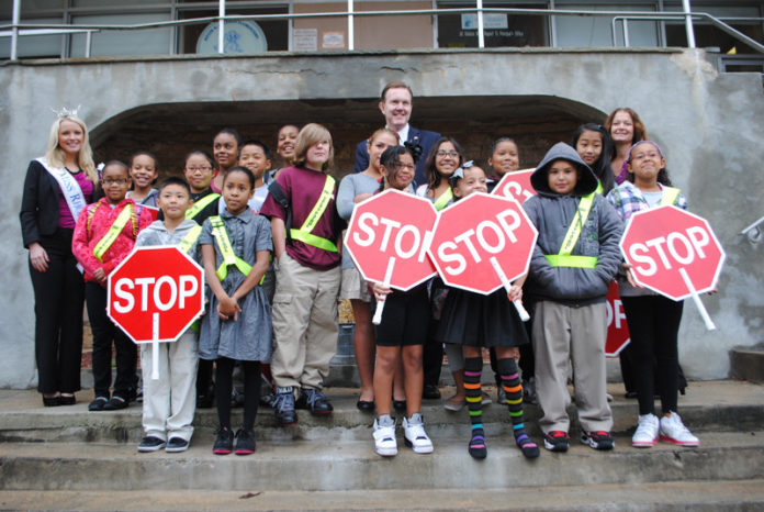 Crossing guards at Woonsocket’s Kevin Coleman Elementary School celebrate International Walk to School Day Oct. 3. Thirty-six schools across the state joined in recognizing the importance of exercise for mental and physical health. In Woonsocket, Mayor Leo Fontaine, rear center, Coleman Principal Lisa Jacques, upper right, and Miss Rhode Island Kelsey Fournier, far left, joined the celebration. Students, parents and teachers also walked and biked to school together. / COURTESY COALITION FOR TRANSPORTATION CHOICES