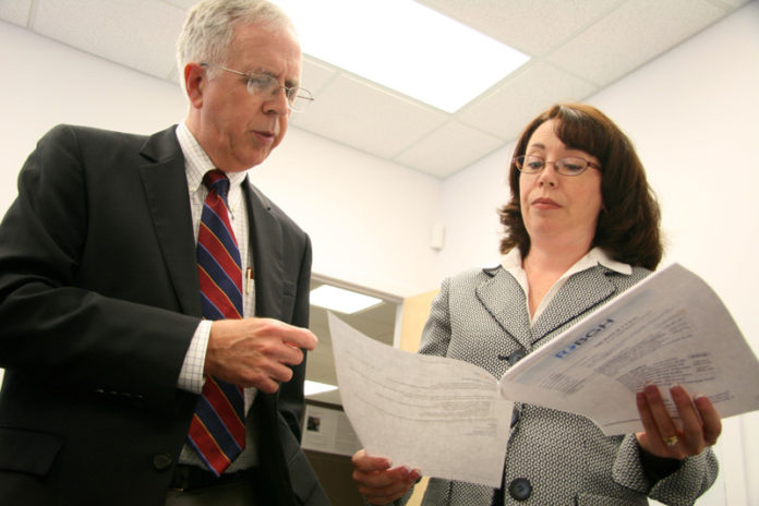 GROUP THINK: Donald Nokes, president of the Rhode Island Business Group on Health, reviews documents with interim Director Kate Kennedy. / PBN PHOTO/MICHAEL PERSSON