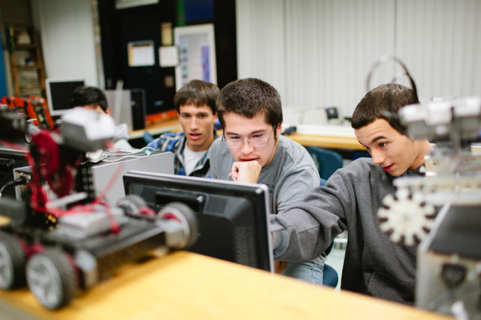 TECHNICAL SUPPORT: William M. Davies School robotics students, from left, Robert Feraria, Zachary Agruedo and Zachary Deschamps, are among the students benefiting from the Grainger donation. / PBN PHOTO/RUPERT WHITELY