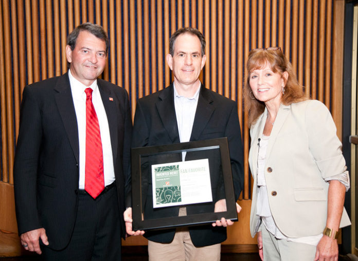 G-FORM LLC executive chairman Danny Warshay (middle) accepts the 