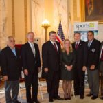 URI MASCOT RHODY THE RAM joins Steve Votolato, president of Soccer Rhode Island; Gov. Lincoln D. Chafee; John Gibbons, executive director of the Rhode Island Sports Commission; Martha Sheridan, president and CEO Providence Warwick Convention & Visitors Bureau; URI President David Dooley; Bob Palmeiro, region I director, US Youth Soccer; and Ed Dombroskas, executive director of Mystic Country to announce that the Ocean State will host the 2013 United States Youth Soccer Region Championships. / COURTESY PROVIDENCE WARWICK CONVENTION & VISITORS BUREUA