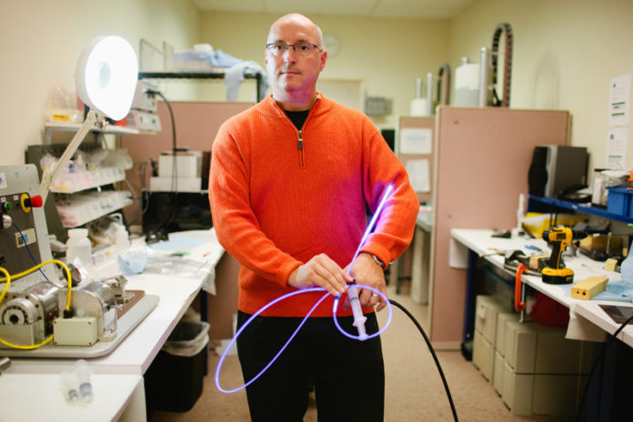 BONE STRUCTURE: IlluminOss President and CEO Scott Rader shows off the company’s photodynamic bone-stabilization system. He says the new round of financing will help the clinical trials that will hopefully lead to the firm’s FDA approval. / PBN PHOTO/RUPERT WHITELEY