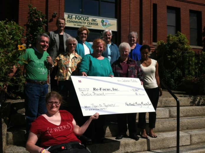 EMPLOYEES AND CLIENTS of Re-Focus Inc. pose for a photo with members of the Sisters of Mercy Northeast Leadership Team, which donated $12,000 to a workforce-development program recently created by Re-Focus.