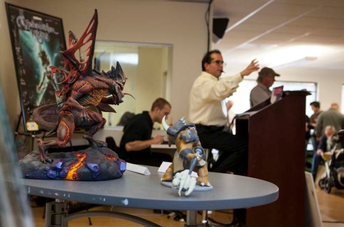 GOING ONCE ... : Models, figurines, office supplies and other items from 38 Studios’ Providence office were up for auction last week. / PBN PHOTO/DAVID LEVESQUE