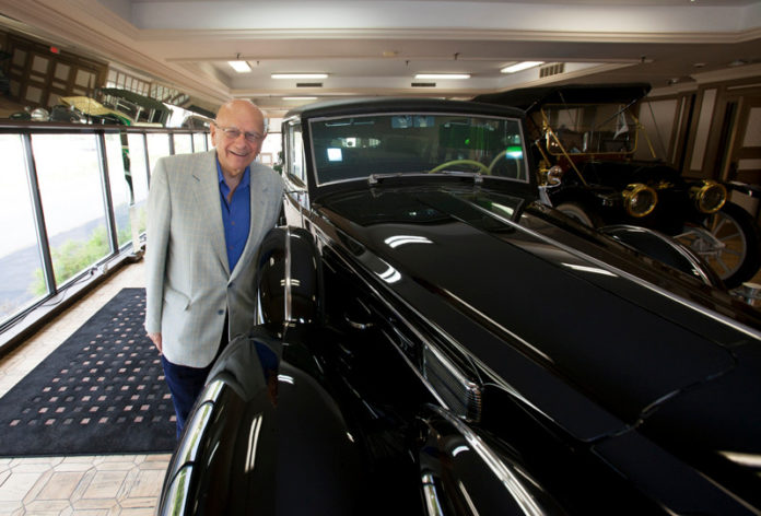 ROCKY ROAD? Leon Kayarian, owner of Celebrity Classic Cars, with a 12-cylinder 1938 Packard limousine once owned by Doris Duke. He says investing in classic cars is becoming more popular. / PBN PHOTO/DAVID LEVESQUE